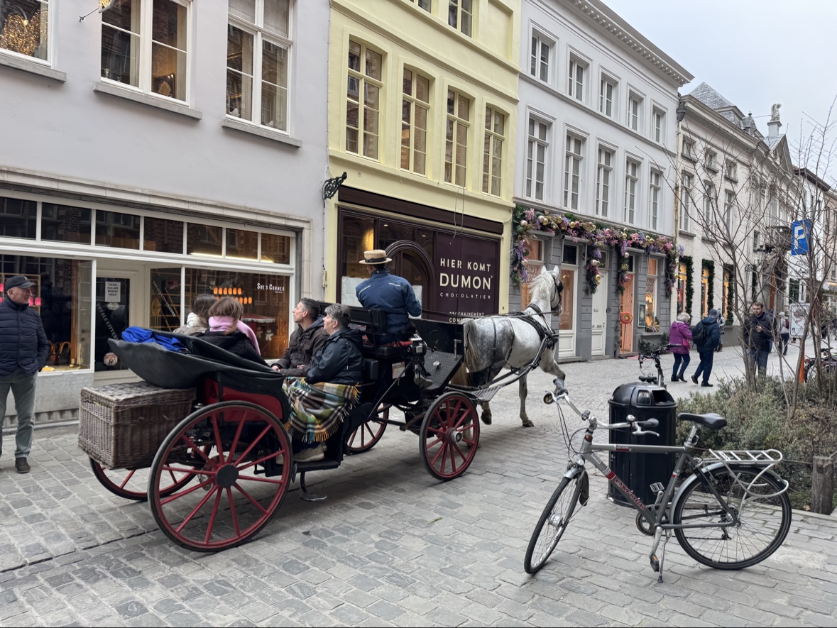 A horse-drawn carriage on a cobbled street in Bruges
