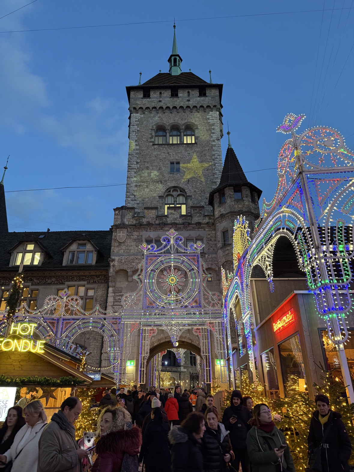 The Illuminarium light show covering a tower facade in Zurich