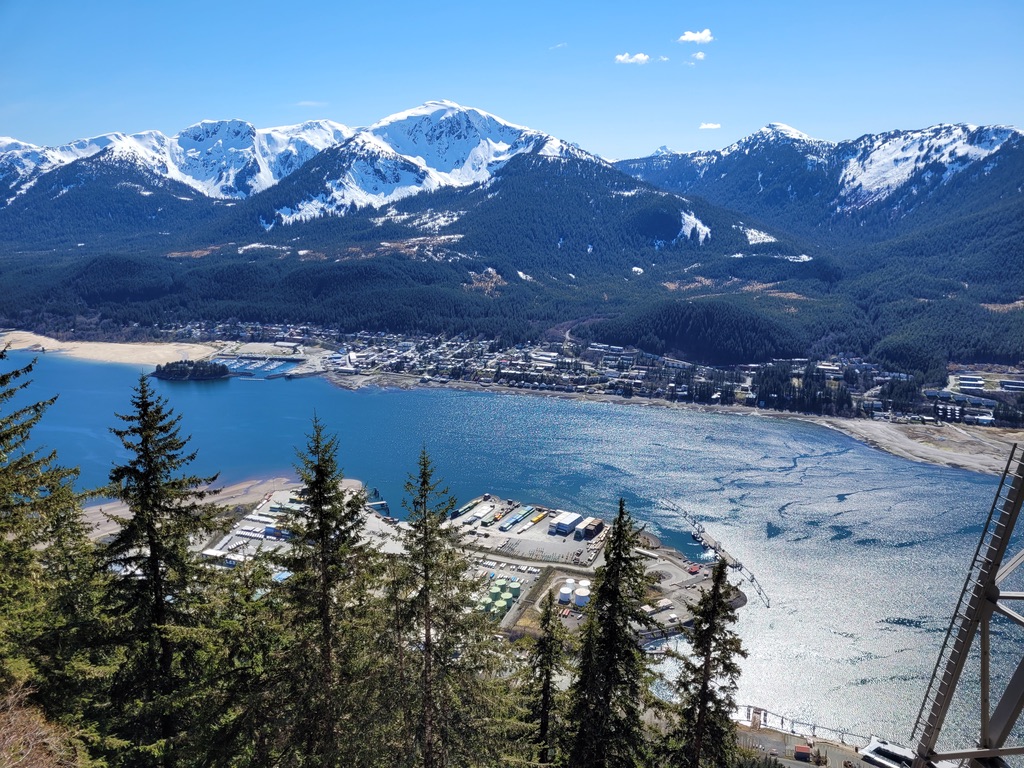 A panoramic view of Juneau, Alaska, with its harbor channel and snow-capped mountains, photographed by Anne Conrad