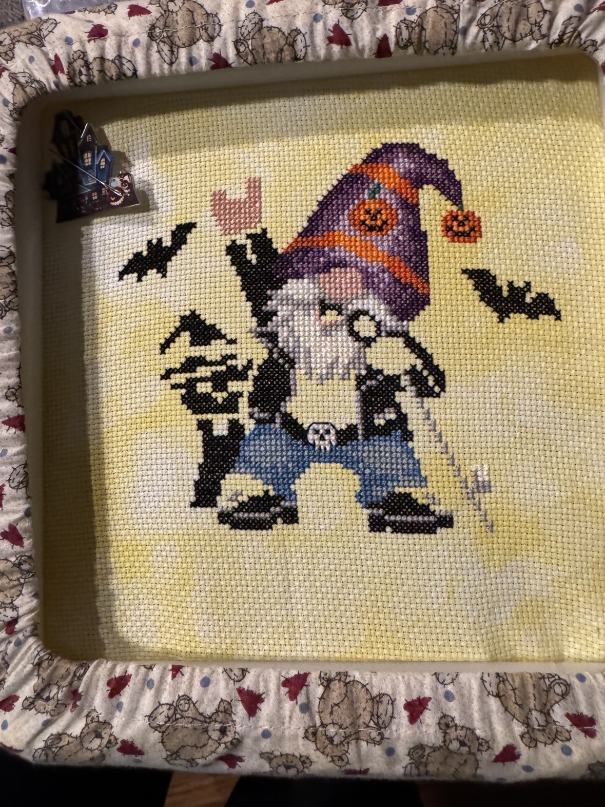 Kathy&rsquo;s cross-stitch work in progress, &ldquo;Totally Rocking Halloween&rdquo; by Michaela Learner — a Halloween gnome in a purple witch hat with bats on either side