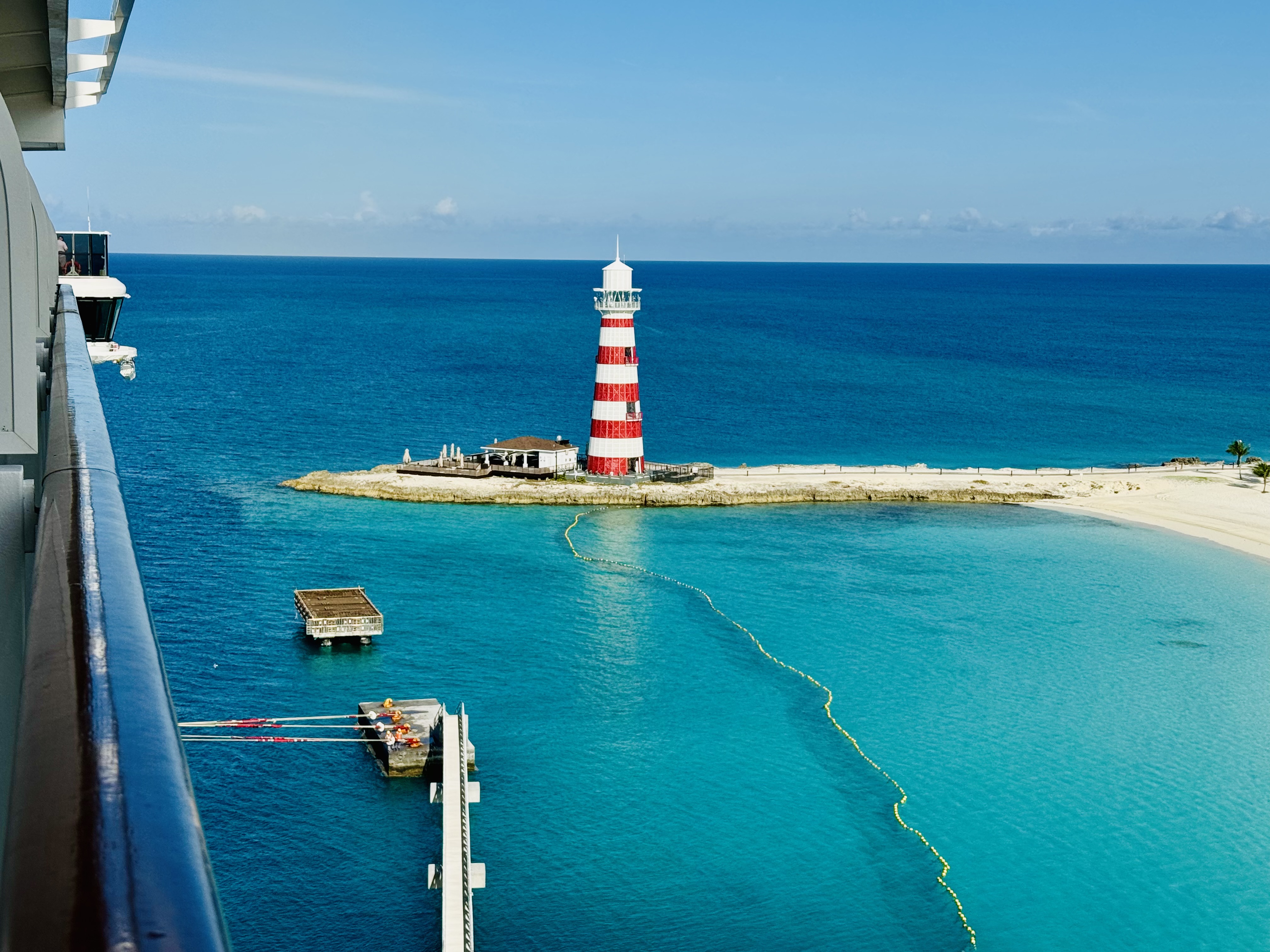 The red-and-white lighthouse at Ocean Cay in the Bahamas, seen from a cruise ship